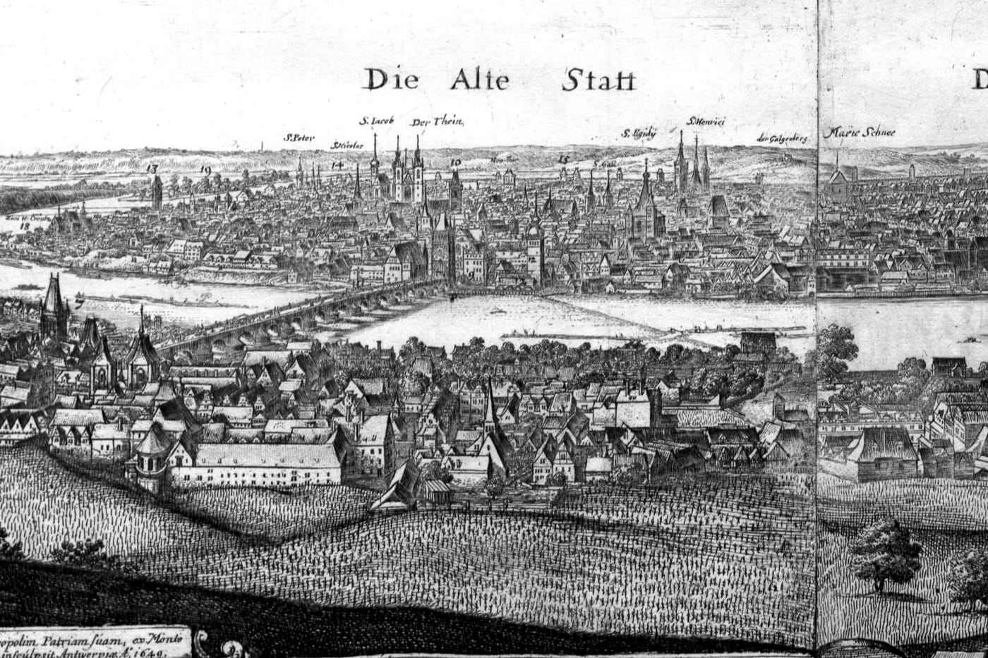 An etched view of Prague across the river: the stone bridge with its tower, the spires of the Týn Church and the roofs of the Old Town